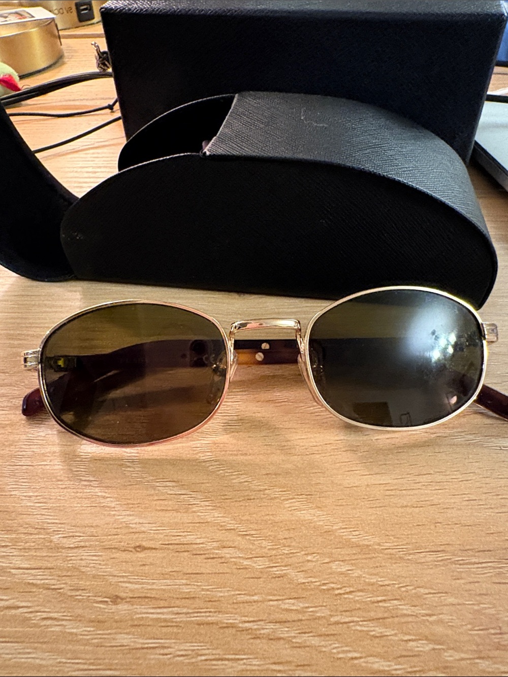 Prada Women’s PR B53 Gold Frame Oval Sunglasses with Brown Lenses
